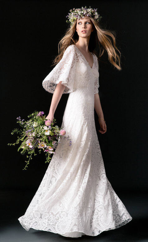 This romantic, bohemian style features an allover embroidered fabric, which is inspired by love charm elements and lacework. Trimmed at the neckline and sleeve with a laurel leaf trim, the