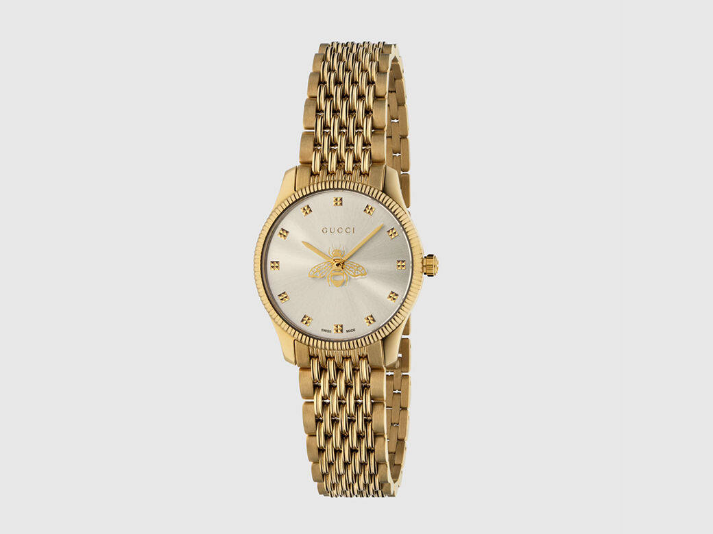 這隻經典的G-Timeless 手錶採用太陽放射飾紋錶盤，以蜜蜂圖案作有趣點綴，屬