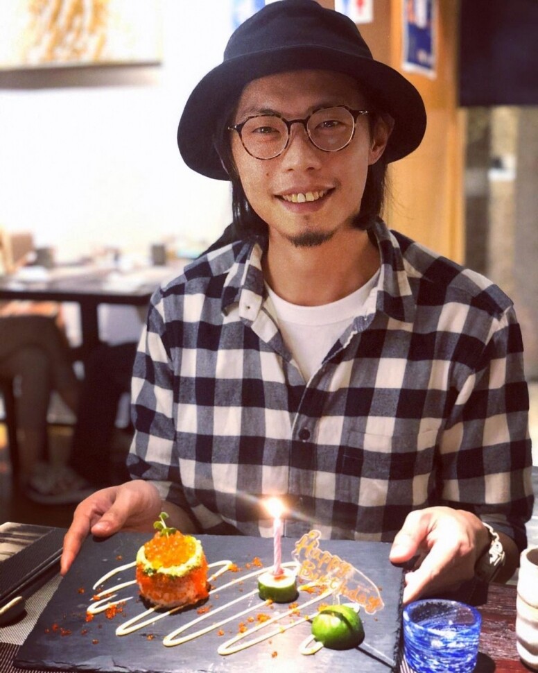 原名麥啟聰的Mike Orange與Jan Curious在2005年成立了樂隊觸執毛，出道後不久樂隊名氣不錯，但他離開樂隊後又回歸樂隊一段短時間，2014年他將事業移往音樂策劃工作，擔任自由野藝術節的策劃人，又擔任薛凱琪音樂會的音樂總監。